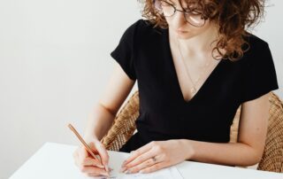 Woman signing document - the importance of a Power of Attorney